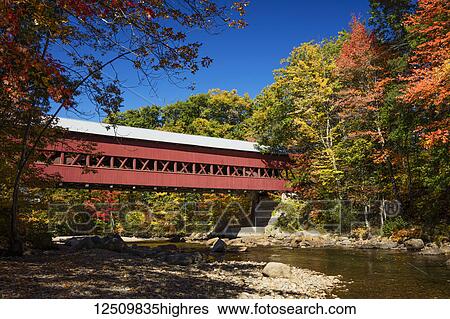 Stock Photograph - Saco River and covered bridge in autumn, White Mountains National Forest; Conway, New Hampshire, United States of America. Fotosearch