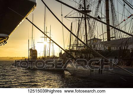 Ship and sailboat in the harbour at sunset; San Diego, California, United States of America View Large Photo Image Stock Photograph - Ship and sailboat in the harbour at sunset; San Diego, California, United States of America. Fotosearch