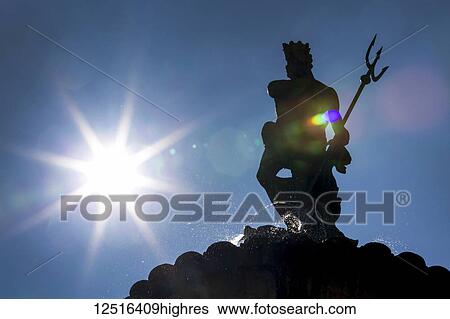 Silhouette of statue on top of fountain with sunburst and blue sky; Trento, Trento, Italy View Large Photo Image Stock Photograph - Silhouette of statue on top of fountain with sunburst and blue sky; Trento, Trento, Italy. Fotosearch