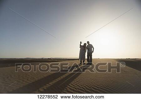 Silhouettes of desert guide and tourist at sunset; Merzouga, Morocco View Large Photo Image Stock Image - Silhouettes of desert guide and tourist at sunset; Merzouga, Morocco. Fotosearch