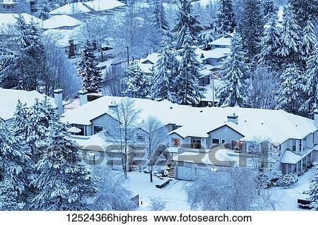 Stock Photograph - Snow covering house rooftops and houses in winter; Surrey, British Columbia, Canada. Fotosearch