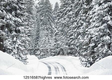 Stock Photograph - Snowy road with icy conditions in the mountains; Keno, Oregon, United States of America. Fotosearch