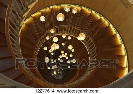 Spiral staircase with lights at Heal's department store, Tottenham Court Road; London, England View Large Photo Image Picture - Spiral staircase with lights at Heal's department store, Tottenham Court Road; London, England. Fotosearch