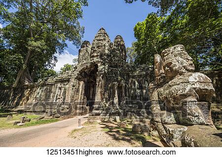 Stock Photograph - Stone figures on the causeway to the Victory Gate tower (Gopuram); Angkor Thom, Siem Reap, Cambodia. Fotosearch