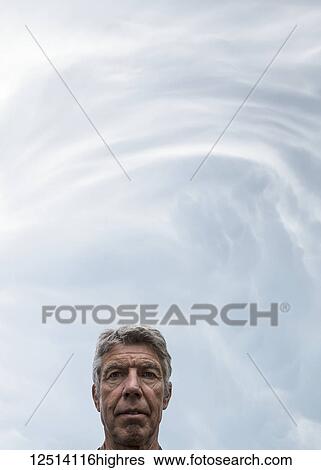 Storm clouds warning of tornadoes and hailstorms above the head of a senior man; Loveland, Colorado, United States of America View Large Photo Image Stock Photograph - Storm clouds warning of tornadoes and hailstorms above the head of a senior man; Loveland, Colorado, United States of America. Fotosearch