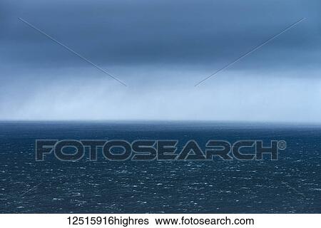 Stock Photograph - Stormy skies over the blue North Atlantic ocean water, Snaefellsnes peninsula; Iceland. Fotosearch