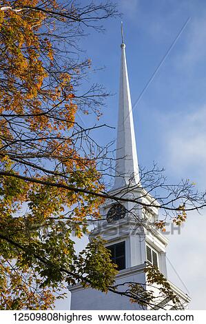 Stowe Church in Vermont with a tall white steeple and clock and tree foliage in autumn colours; Stowe, Vermont, United States of America View Large Photo Image Stock Photograph - Stowe Church in Vermont with a tall white steeple and clock and tree foliage in autumn colours; Stowe, Vermont, United States of America. Fotosearch