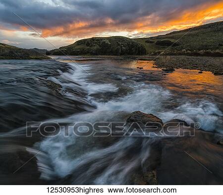 Stunning sunset over an unnamed creek in remote Iceland; Iceland View Large Photo Image Stock Photograph - Stunning sunset over an unnamed creek in remote Iceland; Iceland. Fotosearch