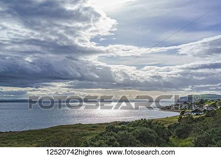 Sunlight illuminates clouds and reflects on the tranquil ocean along the coast of Scotland, Dornoch Firth; Balintore, Scotland View Large Photo Image Stock Photograph - Sunlight illuminates clouds and reflects on the tranquil ocean along the coast of Scotland, Dornoch Firth; Balintore, Scotland. Fotosearch