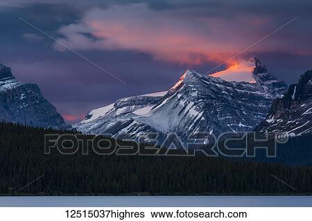 Stock Photograph - Sunrise illuminating the peaks of the Rocky Mountains over Bow Lake, Banff National Park; Improvement District No. 9, Alberta, Canada. Fotosearch