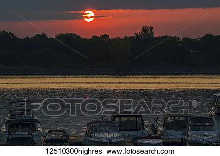 Stock Photograph - Sunrise on the Saint Lawrence River at the Old Port in Montreal; Montreal, Quebec, Canada. Fotosearch