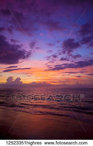 Stock Photograph - Sunset colours lighting oup clouds and ocean; Wailea, Maui, Hawaii, United States of America. Fotosearch