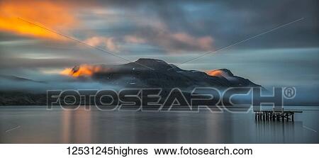 Stock Photograph - Sunset light over the fjord near the remote town of Djupavik along the Strandir Coast; Djupavik, West Fjords, Iceland. Fotosearch