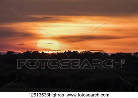 Stock Photograph - Sunset over the Tonle Sap; Siem Reap, Cambodia. Fotosearch