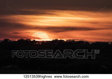 Stock Photograph - Sunset over the Tonle Sap; Siem Reap, Cambodia. Fotosearch