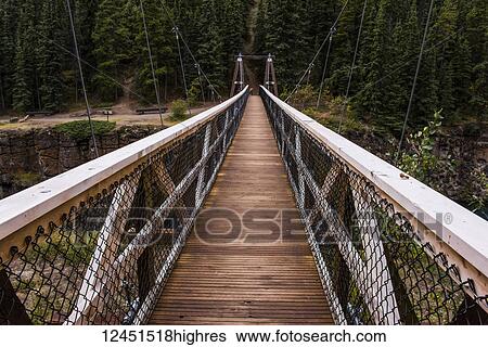 Stock Photograph - Suspension bridge over Miles Canyon; Whitehorse, Yukon, Canada. Fotosearch