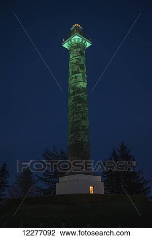 Stock Image - The Astoria Column is turned green to mark Domestic Violence Awareness Month; Astoria, Oregon, United States of America. Fotosearch