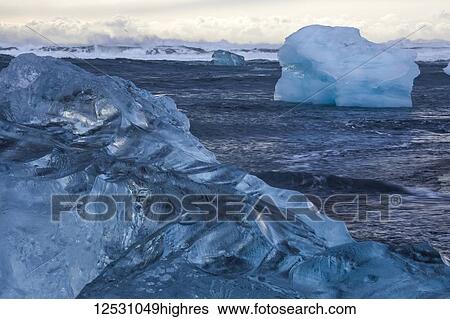 Stock Photograph - The icebergs of Jokulsarlon along the South coast; Iceland. Fotosearch