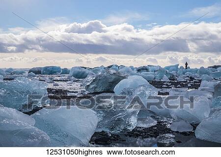 Stock Photograph - The icebergs of Jokulsarlon along the South coast; Iceland. Fotosearch