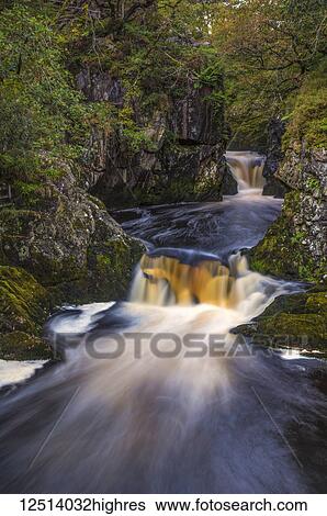 Stock Photograph - The Ingleton Waterfalls Trail, 5 miles long, with a vertical rise of over 500 feet; Ingleton, North Yorkshire, England. Fotosearch