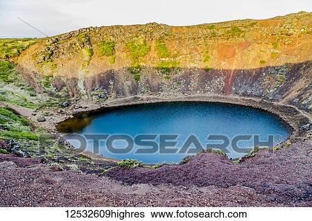 Stock Photograph - The Kerid Volcano Crater is a popular tourist attraction on the Golden Circle route in Western Iceland; Iceland. Fotosearch