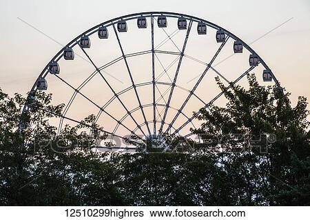 Stock Photograph - The Montreal Observation Wheel at the old Port of Montreal at sunset, 60 metres high; Montreal, Quebec, Canada. Fotosearch
