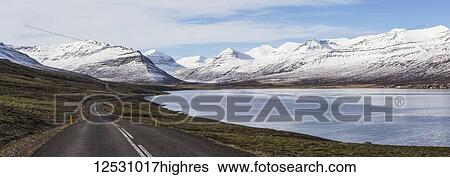 The road running along a fjord on Iceland's East Fjord region seen heading into the mountains; Iceland View Large Photo Image Stock Photograph - The road running along a fjord on Iceland's East Fjord region seen heading into the mountains; Iceland. Fotosearch