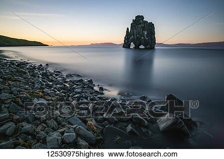 Stock Photograph - The rock formation known as Hvitserkur, at sunset, Northern Iceland; Iceland. Fotosearch