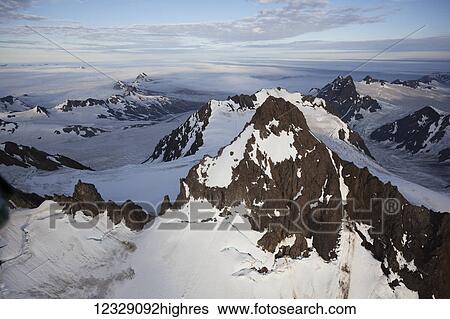 Stock Photograph - The rugged Kenai mountains with snow in Kachemak Bay State Park; Alaska, United States of America. Fotosearch