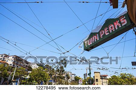 The sign for Twin Peaks Tavern and a grid of cable car wiring against a bright blue sky, Castro District; San Francisco, California, United States of America View Large Photo Image Stock Photography - The sign for Twin Peaks Tavern and a grid of cable car wiring against a bright blue sky, Castro District; San Francisco, California, United States of America. Fotosearch