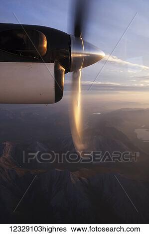 Stock Photograph - The spinning blades of a propeller on a plane over Brooks Range; Alaska, United States of America. Fotosearch