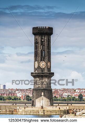 Stock Photograph - The Victoria Tower beyond Collinwood Dock, with houses in the background; Liverpool, England. Fotosearch