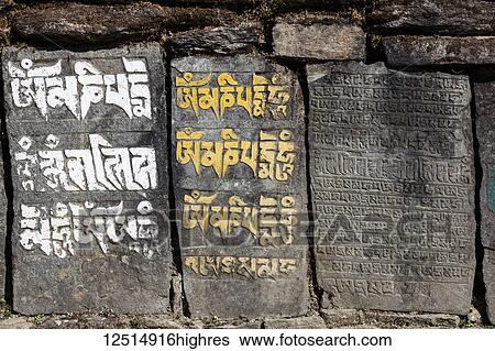 Stock Photograph - Tibetan script on rocks in the Nepalese Himalayas; Nepal. Fotosearch