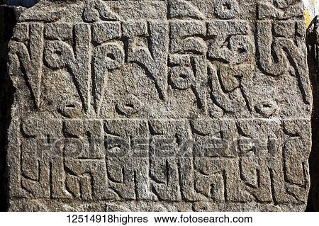 Stock Photograph - Tibetan script on rocks in the Nepalese Himalayas; Nepal. Fotosearch