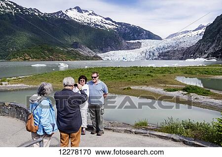 Tourists photographing Mendenhall Glacier and tourists in Tongass National Forest, Southeast Alaska View Large Photo Image Stock Image - Tourists photographing Mendenhall Glacier and tourists in Tongass National Forest, Southeast Alaska. Fotosearch