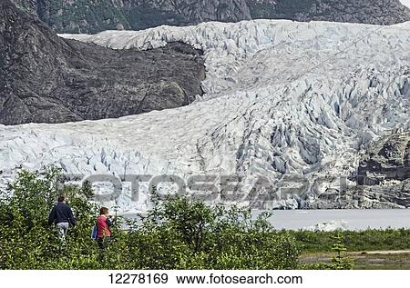 Tourists photographing Mendenhall Glacier in Tongass National Forest, Southeast Alaska, summer View Large Photo Image Stock Photo - Tourists photographing Mendenhall Glacier in Tongass National Forest, Southeast Alaska, summer . Fotosearch