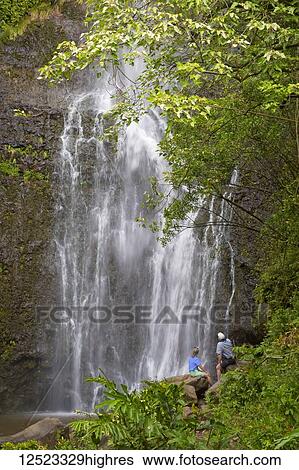 Stock Photograph - Tourists viewing Wailua Falls; Hana, Maui, Hawaii, United States of America. Fotosearch