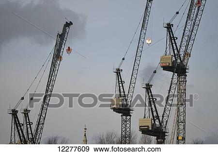 Stock Photo - Tower construction cranes on the north side of the river Thames seen from Blackfriars Bridge; London, England. Fotosearch