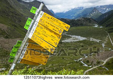 Stock Photograph - Trail signposts on the Tour du Mont Blanc, Val Veni, Alps; Aosta Valley, Italy. Fotosearch
