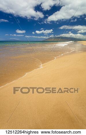 Stock Photograph - Turquoise ocean water and golden sand on Keawakapu Beach; Wailea, Maui, Hawaii, United States of America. Fotosearch