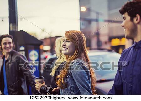 Two couples who are friends walking and holding hands on a popular street at dusk; Edmonton, Alberta, Canada View Large Photo Image Stock Photograph - Two couples who are friends walking and holding hands on a popular street at dusk; Edmonton, Alberta, Canada. Fotosearch