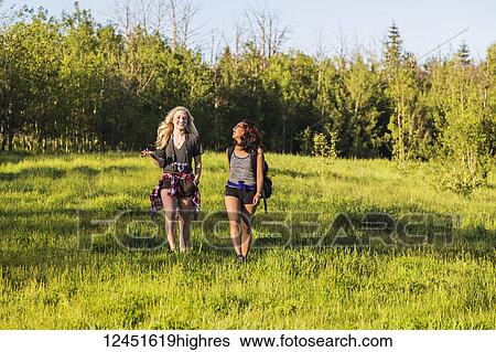Two friends hiking and talking in a park; Edmonton, Alberta, Canada View Large Photo Image Stock Photograph - Two friends hiking and talking in a park; Edmonton, Alberta, Canada. Fotosearch