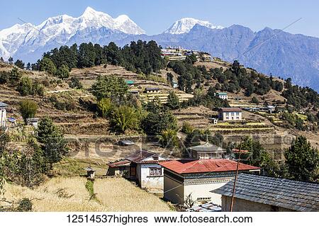 Stock Photograph - Valley landscape view in the Nepalese Himalayas with a Buddhist temple; Nepal. Fotosearch
