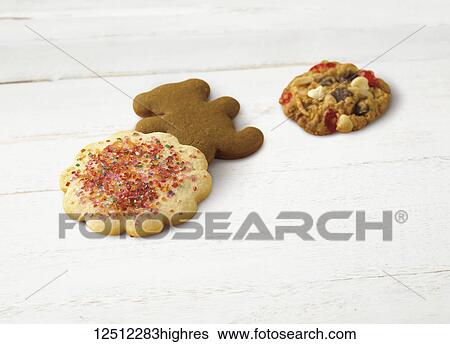 Variety of holiday cookies on a wooden white surface View Large Photo Image Stock Photograph - Variety of holiday cookies on a wooden white surface. Fotosearch