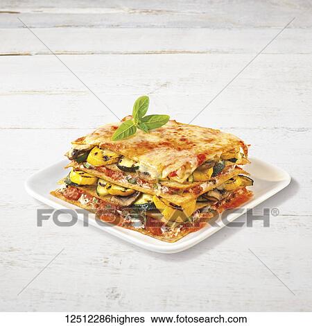 Stock Photograph - Vegetarian lasagna served on a white plate. Fotosearch