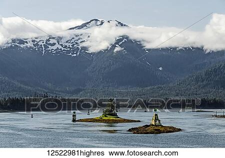 Stock Photograph - View from Alaska State Ferry of Lower Wrangell Narrows toward Wrangell Island, numerous navagation markers visible, and Zarembo Island visible in background; Alaska, United States of America. Fotosearch