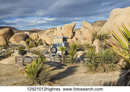 Stock Photograph - View of a campsite with a Sportsmobile Van in Joshua Tree National Park; California, United States of America. Fotosearch