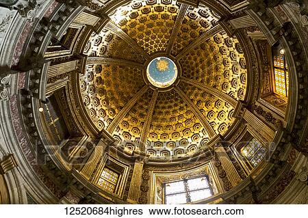 Stock Photograph - View of a cathedral dome with stained glass windows from directly below; Siena, Tuscany, Italy. Fotosearch