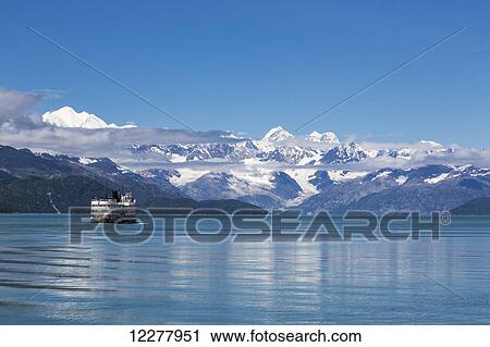 View of a cruise ship in Glacier Bay National Park with the snow capped Fairweather Mountain Range in the background, Southeast Alaska, Summer. View Large Photo Image Stock Image - View of a cruise ship in Glacier Bay National Park with the snow capped Fairweather Mountain Range in the background, Southeast Alaska, Summer.. Fotosearch