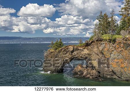 View of a rock arch in Kachemak Bay near Halibut Cove, Southcentral Alaska, Summer. View Large Photo Image Stock Photograph - View of a rock arch in Kachemak Bay near Halibut Cove, Southcentral Alaska, Summer.. Fotosearch